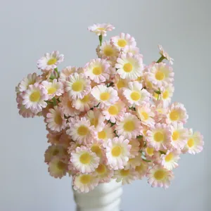 Close-up detail of realistic pink and white artificial daisies in a minimalist vase