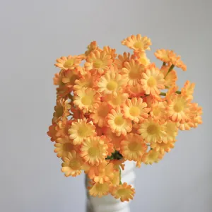 Detailed close-up of vibrant orange artificial daisy bunch for elegant home decoration