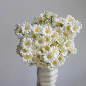 Detailed close-up of artificial white daisies with vibrant yellow centers for home decor