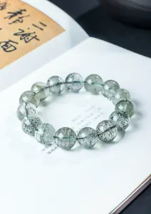 Close-up of natural green phantom quartz beaded bracelet with unique chlorite inclusions.