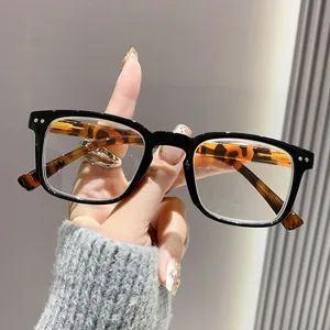 Close-up of retro black square eyeglasses with tortoise temples