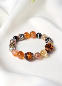 Detailed macro view of Tibetan style crystal bracelet with tiger eye and dZi beads