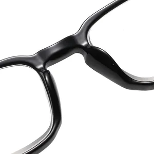 Macro close-up detail of retro black frame reading glasses bridge and nose pads