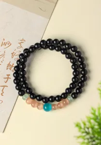 Macro view of natural sandalwood prayer beads with colorful cat's eye stone accents