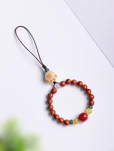 Detail view of handmade cat paw pendant with natural bodhi and colorful beads