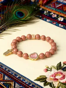 Elegantes handgefertigtes Räucherperlen-Armband mit rosa Kürbis-Anhänger und dekorativer Feder