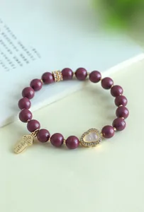 Eleganter lila Perlenarmband mit goldenem Kürbis-Anhänger und Kristall-Akzenten