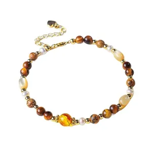 Natuurlijke zoetwaterparel en tijgeroog kralen armband met goudkleurig hartbedeltje