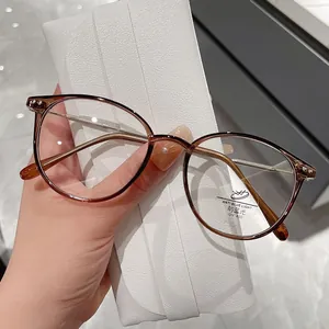 Stylish women's oval anti-blue light glasses with tortoiseshell frame and metal temples
