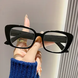 Close-up detail of retro black rectangular frame reading glasses with clear lenses