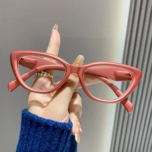 Close-up detail of retro cat-eye reading glasses featuring reddish frame and anti-blue light lenses