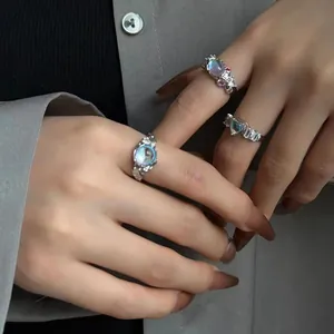 Detailed view of elegant silver open rings featuring moonstones and heart-shaped zircons.