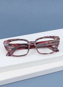 Close-up side view of retro leopard print reading glasses on white display stand