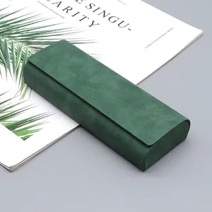 Primer plano detallado de un estuche de gafas de alta gama en cuero de ante verde.