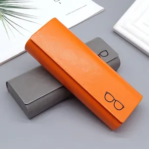 Estuches de cuero minimalistas para gafas en naranja y gris en un entorno elegante