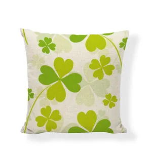 Close-up detail of a linen pillowcase featuring green shamrock clover prints.