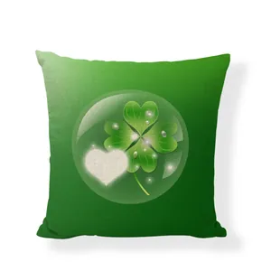 Detail view of green linen pillowcase with lucky four-leaf clover and heart print motif.