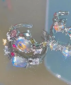 Macro view of silver lava ring set with vibrant zircons and opalescent stones.