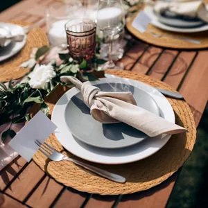 Detailed macro view of a natural round straw woven placemat on a wooden dining table