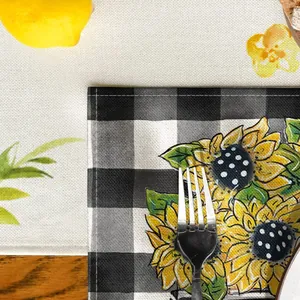 Close-up of cotton fabric placemat featuring buffalo plaid and sunflower pattern