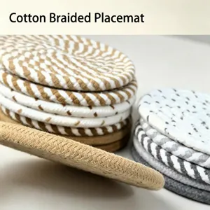 Detail view showing the thick texture of hand-woven cotton rope coasters in neutral tones.