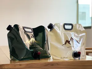 Two 8L portable collapsible outdoor water bags with handles and spigots on a wooden table