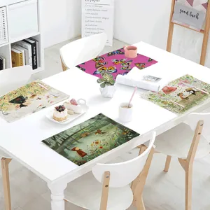 Four patterned spring linen placemats displayed on a modern white dining table setup