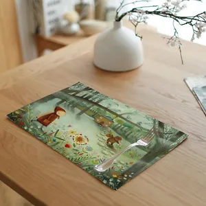 Close-up of a linen placemat with a fairytale forest illustration on a wooden table
