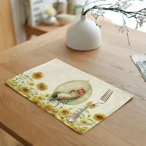 Linen table mat detail showing a cute sleeping cat illustration and sunflowers.
