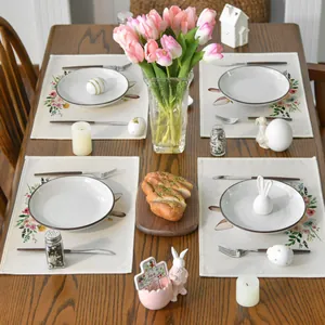 Set of 4 washable linen placemats with botanical floral and bunny prints on wooden table