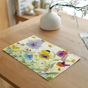 Watercolor spring flower linen placemat on a wooden dining table with fork detail