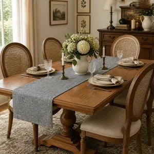 Elegant close-up of a thick grey textured linen table runner on a rustic wooden table