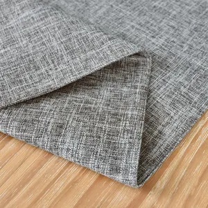Macro view showing the thick texture of a grey linen table runner on a wooden surface