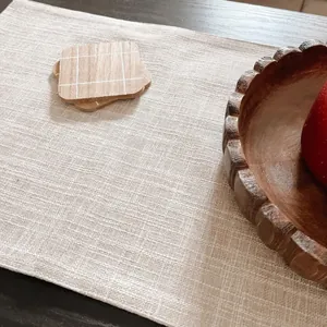 Detailed close-up showing the textured fabric of a beige thick linen table runner on wood table
