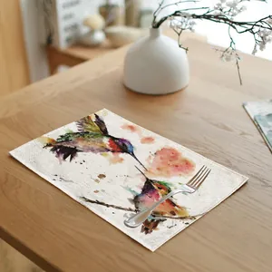 Detailed view of hummingbird watercolor art print on a premium linen fabric placemat