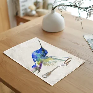 Detail view of a linen cotton placemat with a colorful watercolor hummingbird print.