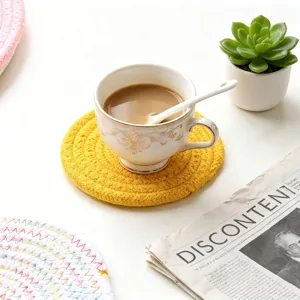 Handcrafted yellow round woven cotton rope coaster for tabletop heat protection and decoration