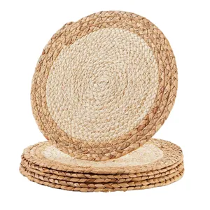 Set of hand-woven round straw placemats for heat insulation and table protection
