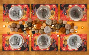 Halloween placemats with pumpkins and Trick or Treat design on a festive table