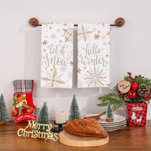 Pair of festive Christmas kitchen towels with snowflakes and seasonal calligraphy