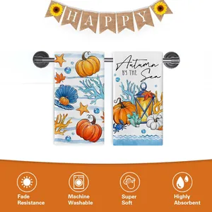 Detail view of highly absorbent autumn-themed kitchen towels with decorative pumpkin designs.