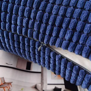 Close-up of blue corduroy cushion cover showing corn grain texture and hidden zipper.