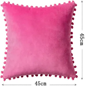 Close-up of 45x45cm dimensions on a pink velvet pom-pom throw pillow cover for sofa