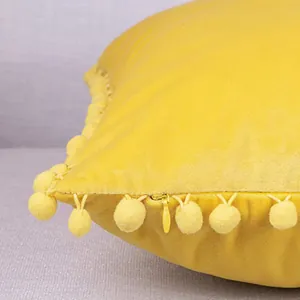 Yellow velvet pillow case with pom-pom trim and concealed zipper for home sofa decor