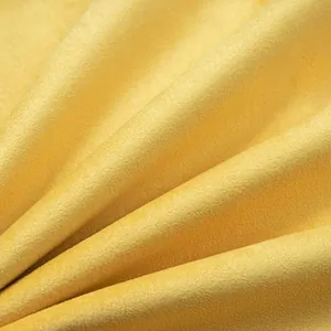 Close-up of yellow velvet cushion cover fabric text