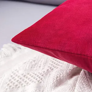 Macro view of the luxury red velvet cushion cover showing soft fabric texture and stitching