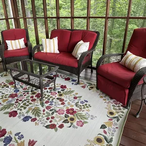 Bohemian style textured pillow covers displayed on outdoor wicker sofas with red cushions