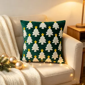 Green velvet Christmas tree embroidered throw pillow cover styled on a warm sofa