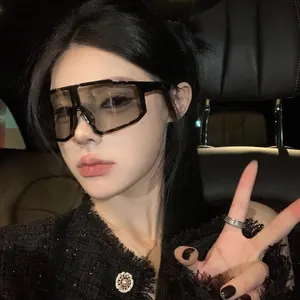 Asian model wearing oversized cycling sunglasses in black frame for windproof protection