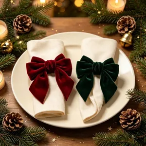 Close-up of elegant red and green velvet bow napkin rings for Christmas table decor